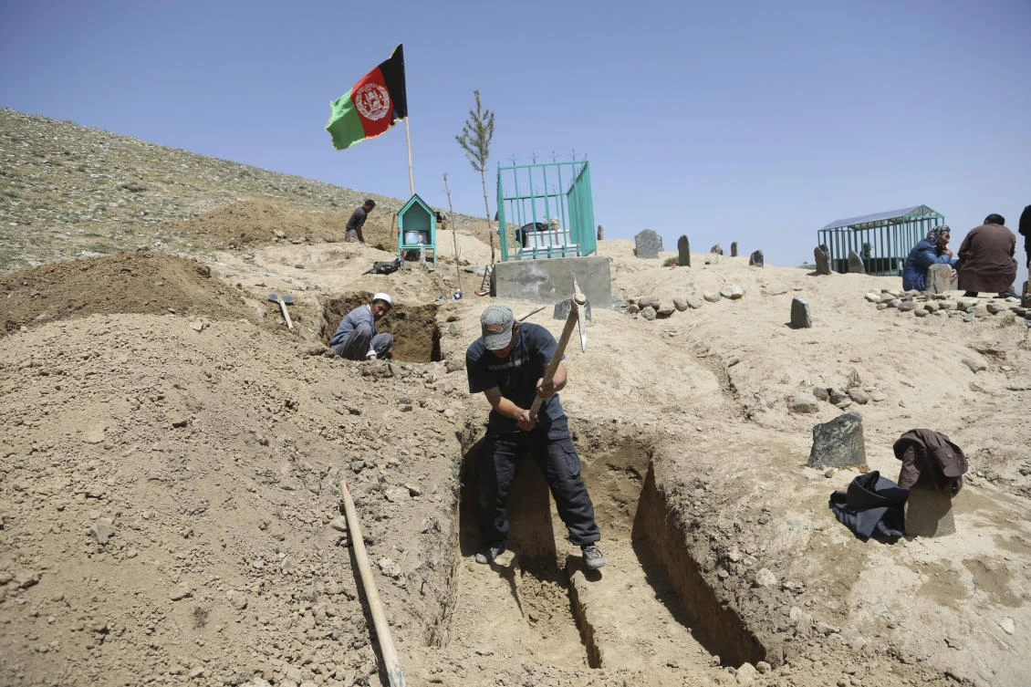 Afghan men prepare the graves for the victims of Sunday’s suicide attack at a voter registration center, in Kabul. A Taliban attack early Tuesday has killed four local policemen and wounded seven in eastern Ghazni province. (AP)