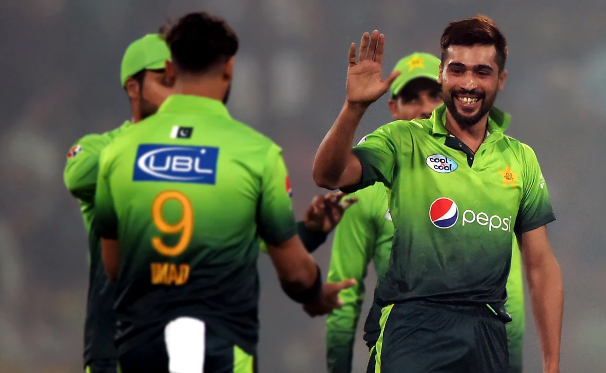 In this file photo, Pakistani bowler Mohammad Amir, center, celebrates with teammates after dismissing Sri Lankan batsman Dilshan Munaweera during the final T20 cricket match against Sri Lanka at the Qaddafi Cricket Stadium in Lahore, Oct. 29, 2017. (AFP)