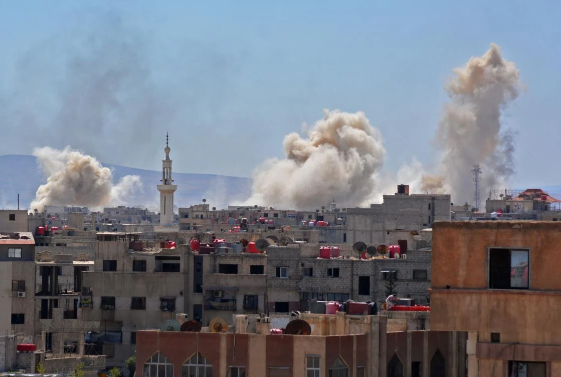Smoke billows during Syrian army air strikes as seen from the Yarmuk Palestinian refugee camp in southern Damascus. (AFP)
