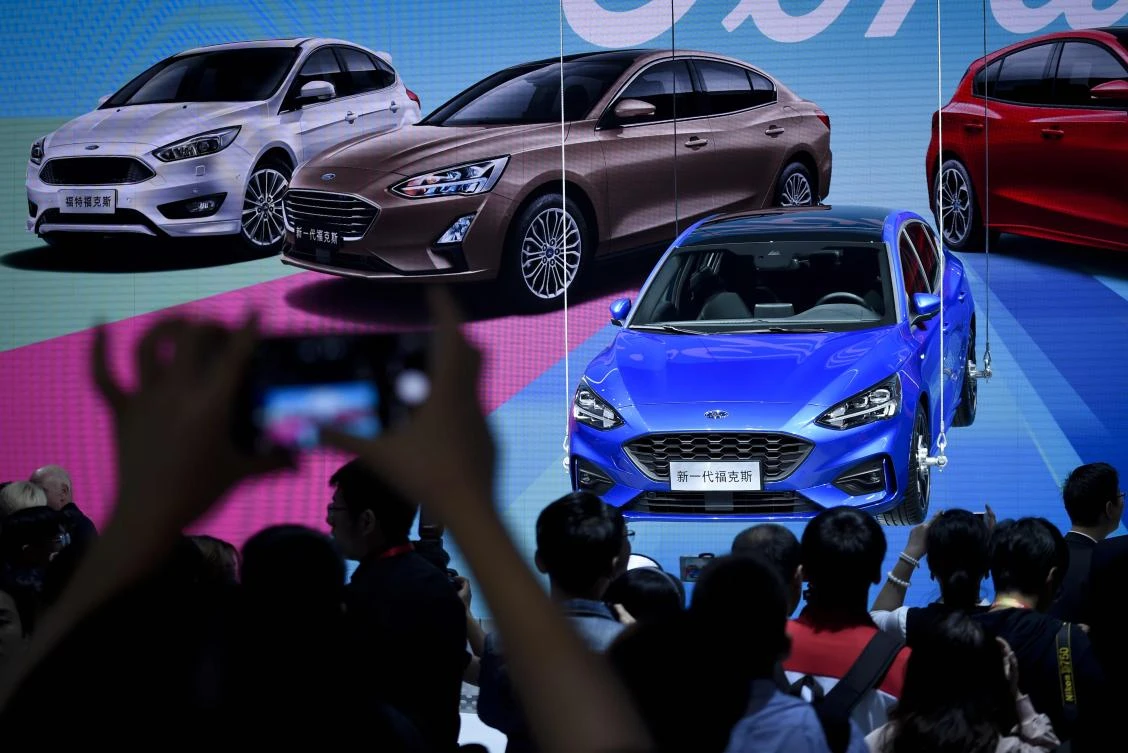 Visitors look at a display for the new Ford Focus at the Beijing auto show on Tuesday, April 25. Thousands of Chinese auto enthusiasts are expected to wander the halls of the mega exhibition center this week, with electric cars and gas-guzzling sport-utility vehicles grabbing the spotlight. (AFP)