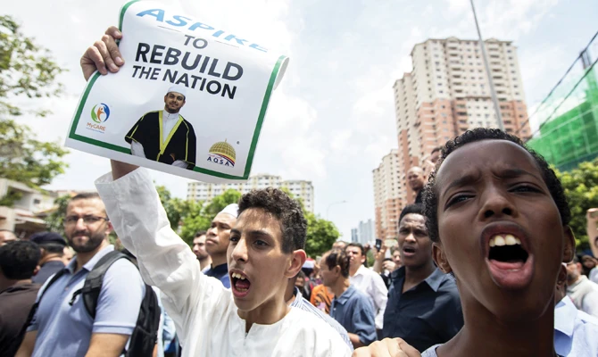 Friends and supporters of Palestinian Fadi Al-Batsh participate at a prayer in Selayang, a neighborhood of Kuala Lumpur on Wednesday. (Getty Images)