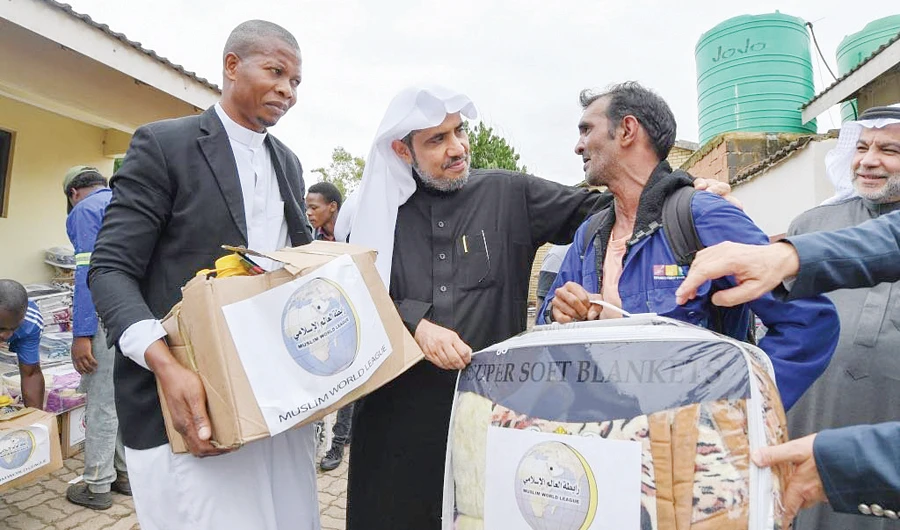 Muslim World League Secretary-General Mohammed bin Abdul Karim Al-Issa distributes aid packets among poor families in Comoros. (SPA)