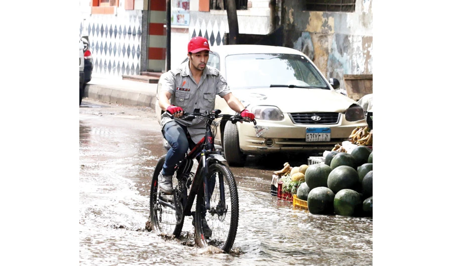 Cars drive through a flooded street after a flash flood affected Cairo, Egypt, on Thursday. EPA