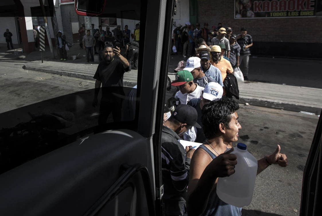 Migrants in a caravan of Central American asylum-seekers board a bus in Mexicali, Mexico on Thursday, April 26, for a two-hour drive to Tijuana to join up with about 175 others who already arrived. (AP)