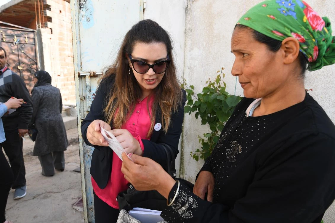 Ines Boussetta, a candidate for the ruling Nida Tounes party, hits the campaign trail in northern Tebourba. (AFP)