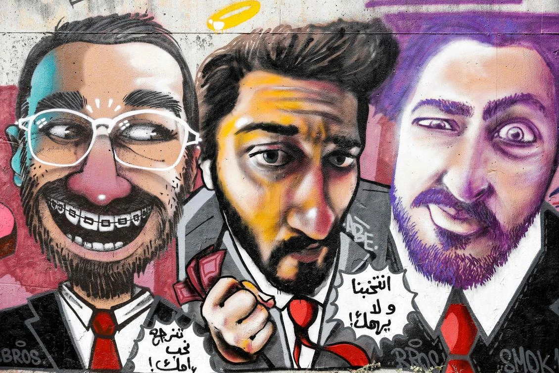 Above, graffiti on a wall in the Lebanese capital Beirut depicting fictional politicians running in the upcoming parliamentary polls scheduled for May 6, with speech bubbles below the faces reading in Arabic “Vote for us, no matter. So we can love your mother again.” (AFP)