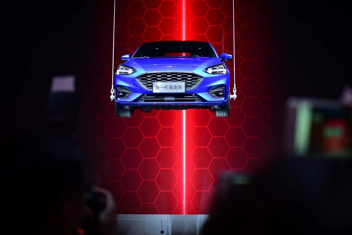 The new Ford Focus is suspended in air on display at the Beijing auto show. As China aims to roll out 5G super-fast mobile networks that will allow for quick communication between vehicles, automakers such as Ford are looking at how vehicles can better communicate with each other. (AFP)