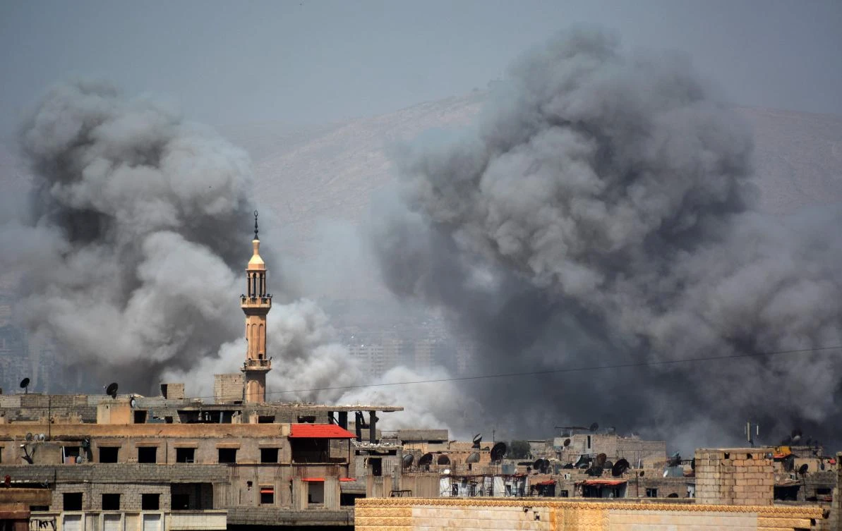 A picture taken in the Yarmuk Palestinian refugee camp in southern Damascus on April 27, 2018 shows smoke billowing in the area during Syrian army shelling and airstrikes. (AFP)