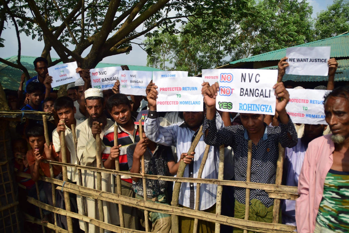 Rohingya refugees hold placards to members of United nations Security Council team during their visit to Kutupalong refugee camp in Bangladesh’s Ukhia’s district on 29 April 2018. (Sam Jahan/AFP)