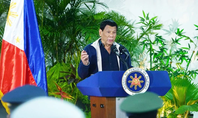 Philippine President Rodrigo Duterte addresses media at the Davao international airport, southern Philippines, after returning from the 32nd ASEAN Summit in Singapore. (Office of the President photo)