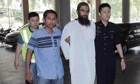 Danish national Salah Salem Saleh Sulaiman, second from right, escorted by police, arrives at a court house in Kuala Lumpur, Malaysia, Monday, April 30, 2018. (AP)