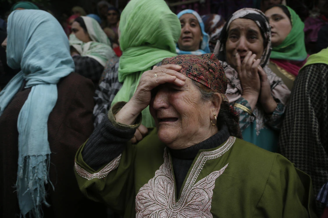 Family members and neighbors of slain political worker Ghulam Nabi Patel cry during his funeral at Dangarpura 47 Kilometers (29 miles) south of Srinagar, Indian controlled Kashmir, Wednesday, April 25, 2018. (AP)