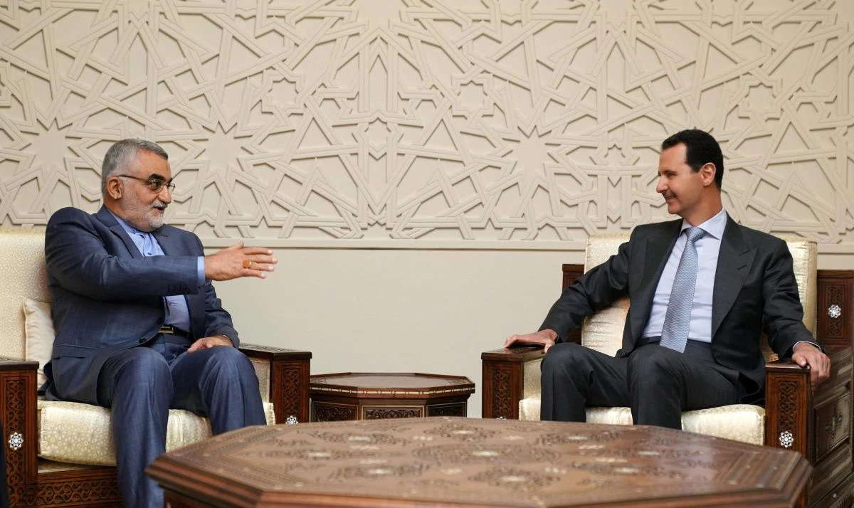Photo showing Syrian President Bashar al-Assad receiving the chairman of the Iranian parliament’s national security committee Alaeddin Boroujerdi in Damascus (AFP)