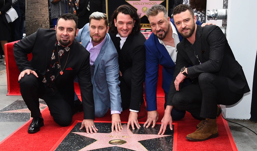 Chris Kirkpatrick, from left, Lance Bass, JC Chasez, Joey Fatone and Justin Timberlake of the band NSYNC appear at a ceremony honoring them with a star on the Hollywood Walk of Fame on Monday, April 30, 2018, in Los Angeles. (Invision/AP)