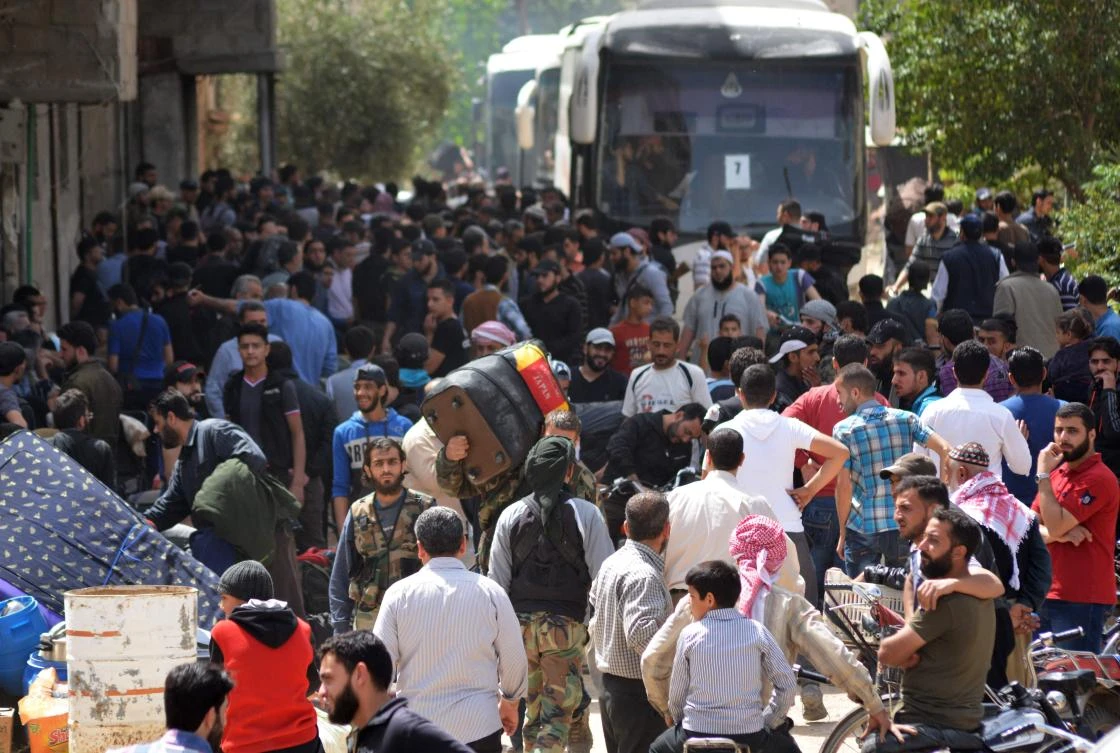 Syrian rebels and civilians prepare to be evacuated from the town of Yalda on the southern outskirts of Damascus on May 3 under a negotiated withdrawal. (AFP)