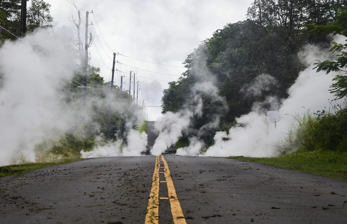 Steam rises from a fissure on a road in Leilani Estates subdivision on Hawaii’s Big Island on May 4, 2018. Up to 10,000 people have been asked to leave their homes on Hawaii’s Big Island following the eruption of the Kilauea volcano that came after a series of recent earthquakes. (Frederic J Brown/AFP)