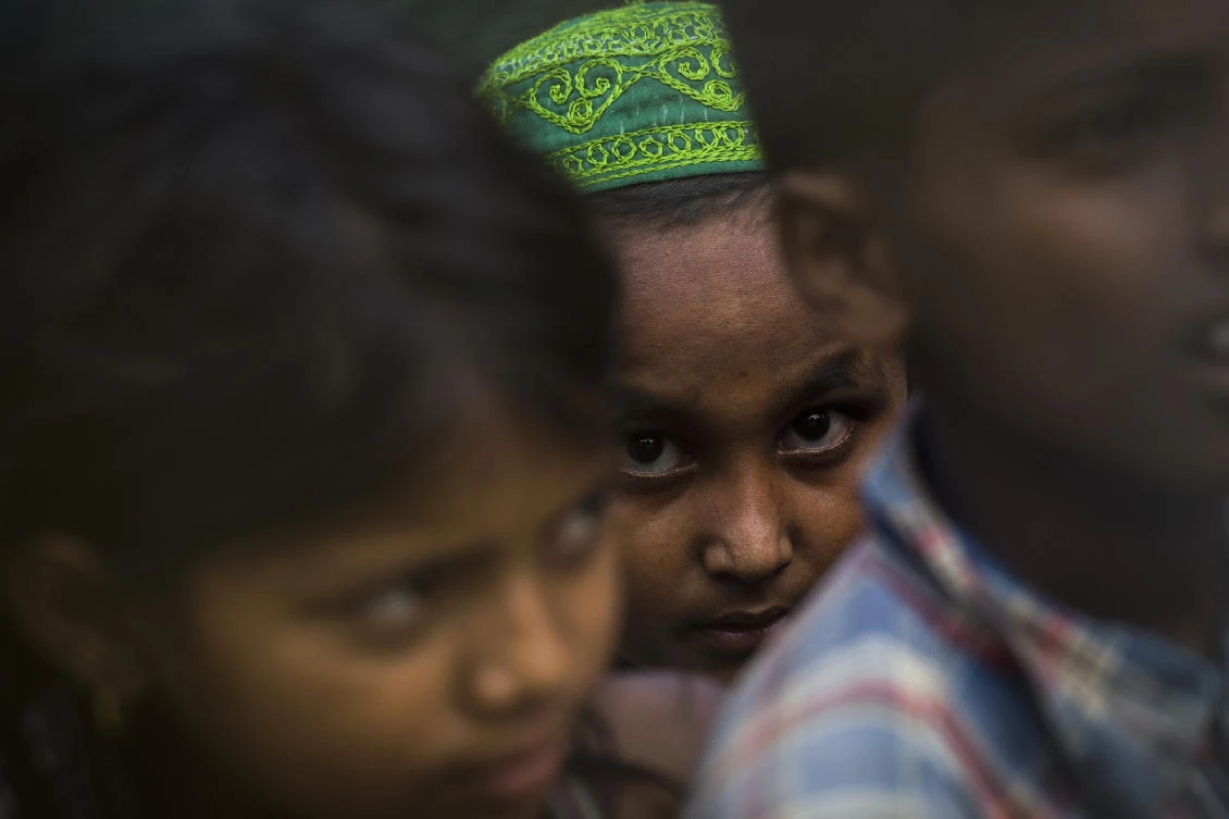 Rohingya refugee children gather in the “no man’s land” behind Myanmar’s boder lined with barb wire fences in Maungdaw district, Rakhine state bounded by Bangladesh on April 25, 2018. (Ye Aung Thu/AFP)