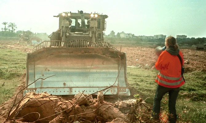 American peace activist Rachel Corrie tries to stop an Israeli bulldozer from destroying Palestinian homes on March 16, 2003, in a refugee camp in the Gaza Strip. (Getty Images)