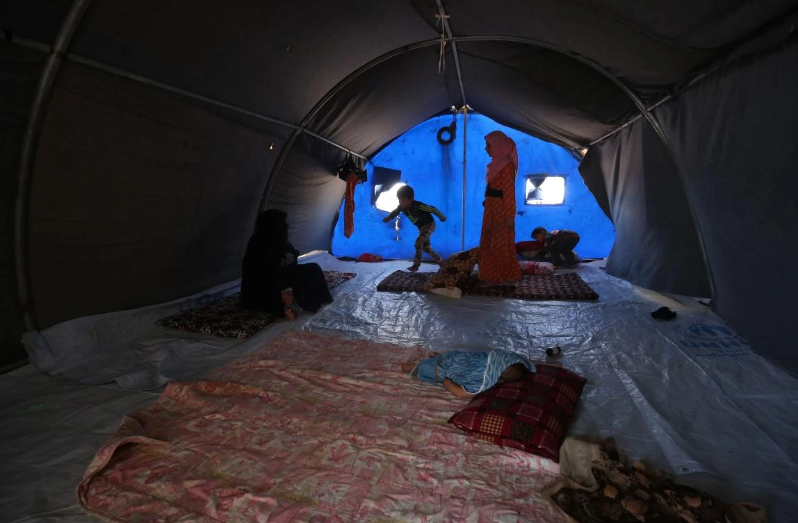 Displaced Iraqis are seen in a tent where they are taking shelter in “Camp Seven” near Al-Khalidiyeh in Iraq’s western Anbar province on April 24, 2018. (AFP/ Ahmad Al-Rubaye)