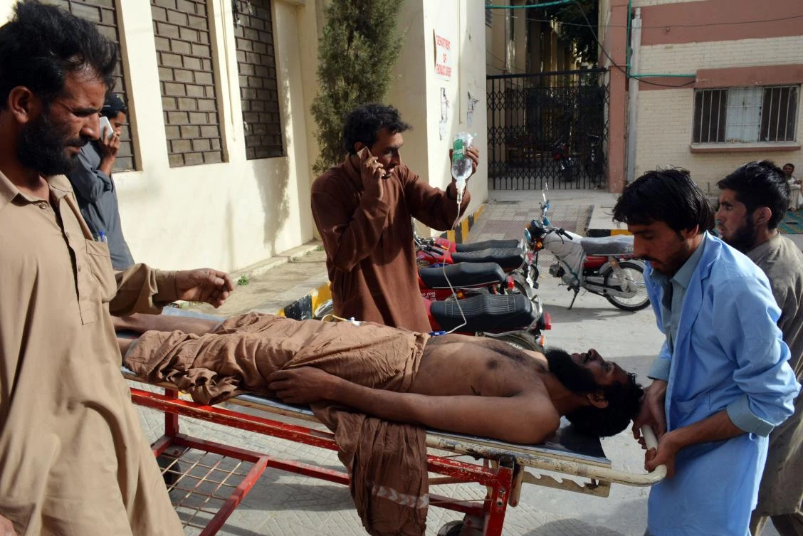 Pakistani miners carry an injured colleague on a stretcher to the hospital after the collapse of coal mine in Quetta on May 5, 2018. Sixteen miners were killed and nine others were wounded on May 5 when a coal mine collapsed due to a gas explosion in southwestern Pakistan, officials said. (AFP/Banaras Khan)