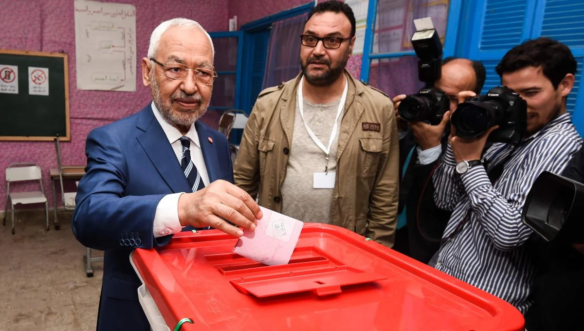 Rached Ghannouchi (L), leader of the Tunisian Islamist Ennahda party, casts his ballot in a box at a polling station in Ben Arous near the capital Tunis on May 6, 2018, as the country votes in the first free municipal elections since the 2011 revolution. (AFP/Fethi Belaid)