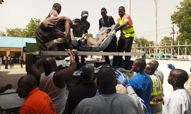People unload from a truck to a morgue the bodies of victims in Bama, Borno State, northeastern Nigeria, on April 22, 2018, following twin suicide blasts by suspected Boko Haram extremists inside of a mosque. (AFP file photo)