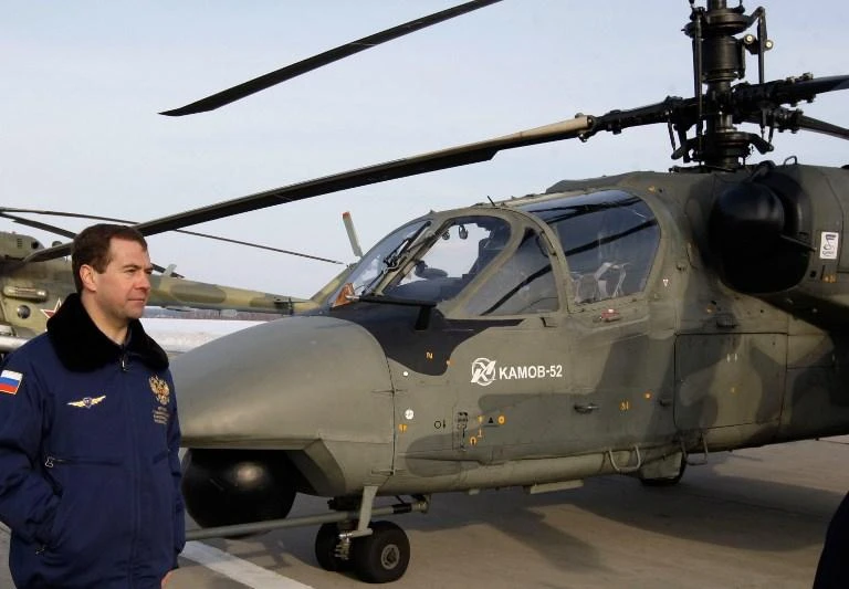 Russia’s Dmitry Medvedev stands next to a Ka-52 helicopter gunship, the same type as the one that crashed in Syria late Monday, in this photo taken at the Kubinka airfield near Moscow on March 28, 2009. (RIA-Novosti Kremlin Pool via AFP)