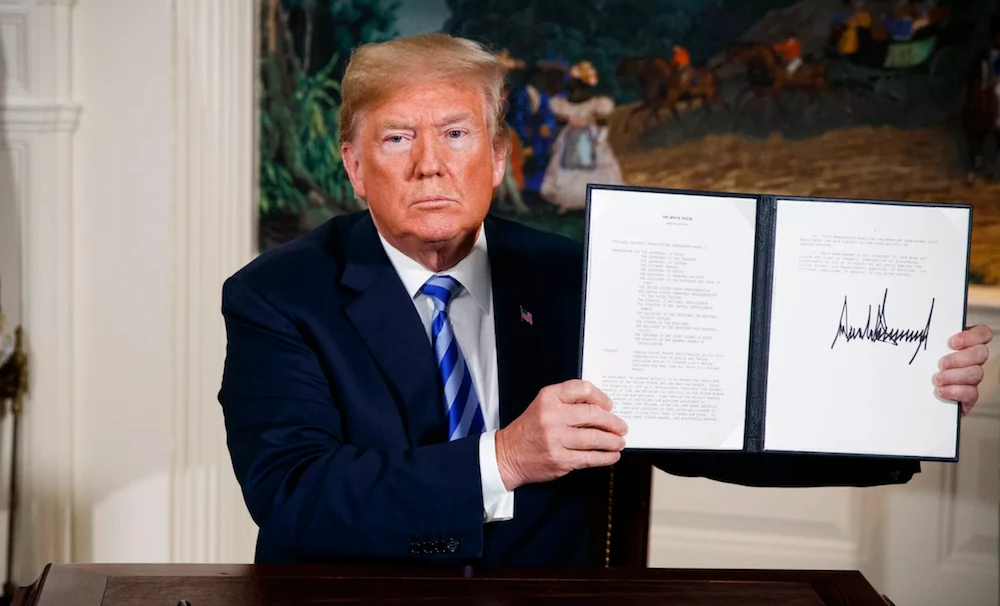 President Trump shows a signed Presidential Memorandum after delivering a statement on the Iran nuclear deal on May 8, 2018. (AP)