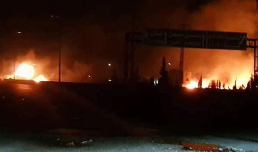 This photo released on Wednesday, May 9, 2018, by the Syrian official news agency SANA, shows flames rising after an attack in an area known to have numerous Syrian army military bases, in Kisweh, south of Damascus, Syria. (SANA via AP)