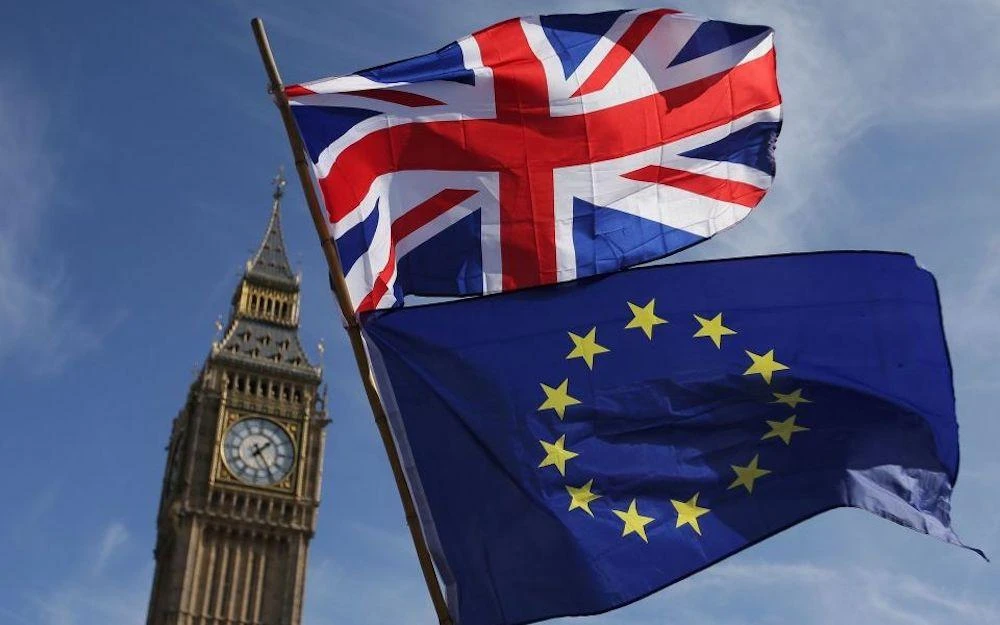 In this file photo taken on March 25, 2017 an EU flag and a Union flag held by a demonstrator is seen with Elizabeth Tower (Big Ben) and the Houses of Parliament. (Daniel Leal-Olivas/AFP)