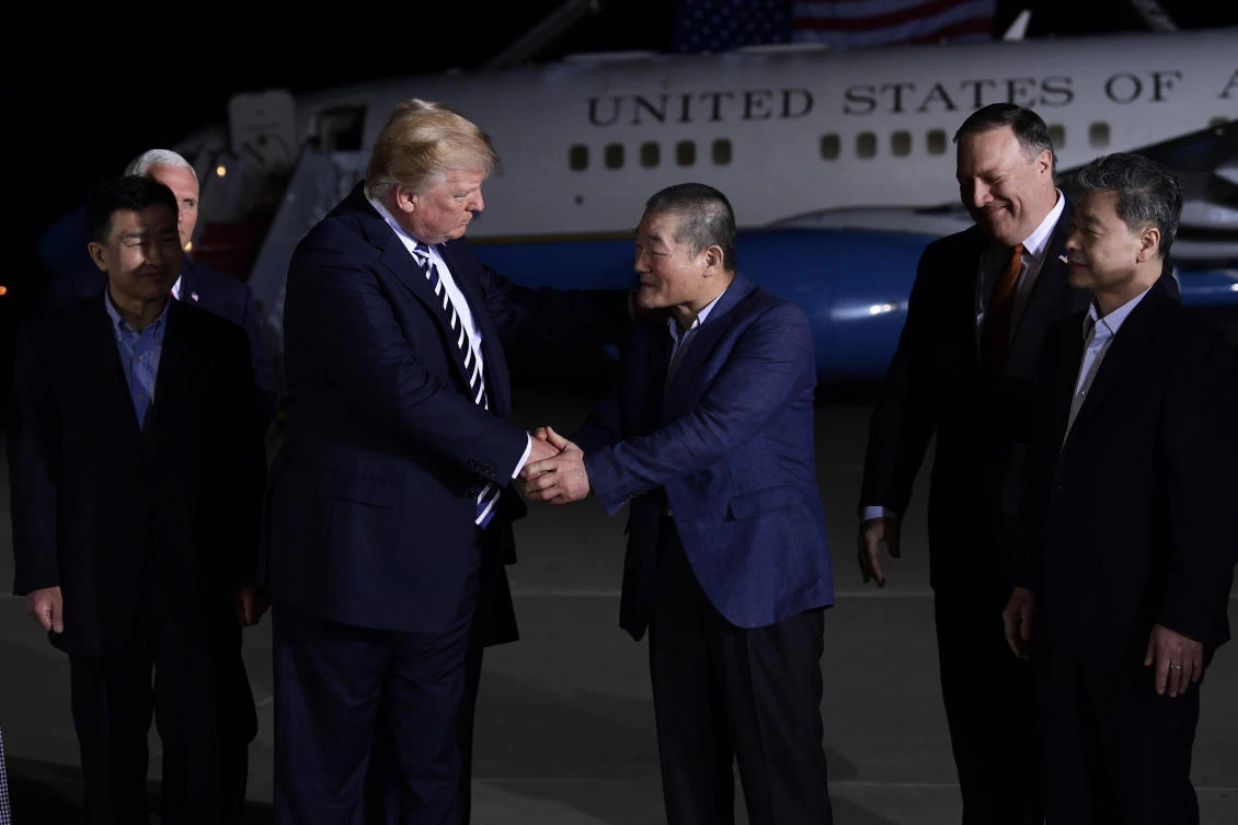 President Donald Trump, center left, shakes hands with Kim Dong Chul, with Tony Kim, far left, and Kim Hak Song, far right, the three Americans who were detained in North Korea for over a year, upon their arrival at Andrews Air Force Base. (AP)