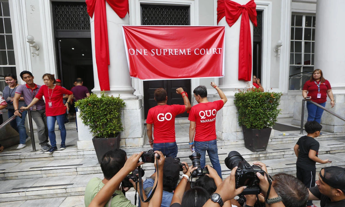 Philippine Supreme Court employees pose with clenched fists to express support for the ouster of embattled Philippine Supreme Court Chief Justice Maria Lourdes Sereno on Friday, May 11. (AP)