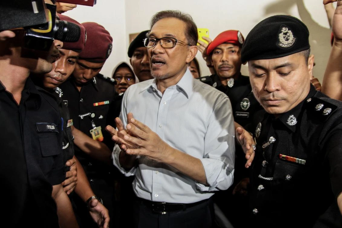 Jailed opposition leader Anwar Ibrahim walks out from a court house in Kuala Lumpur. Malaysia’s king has agreed to pardon jailed opposition leader Anwar Ibrahim immediately, Prime Minister Mahathir Mohamad said. (AFP)