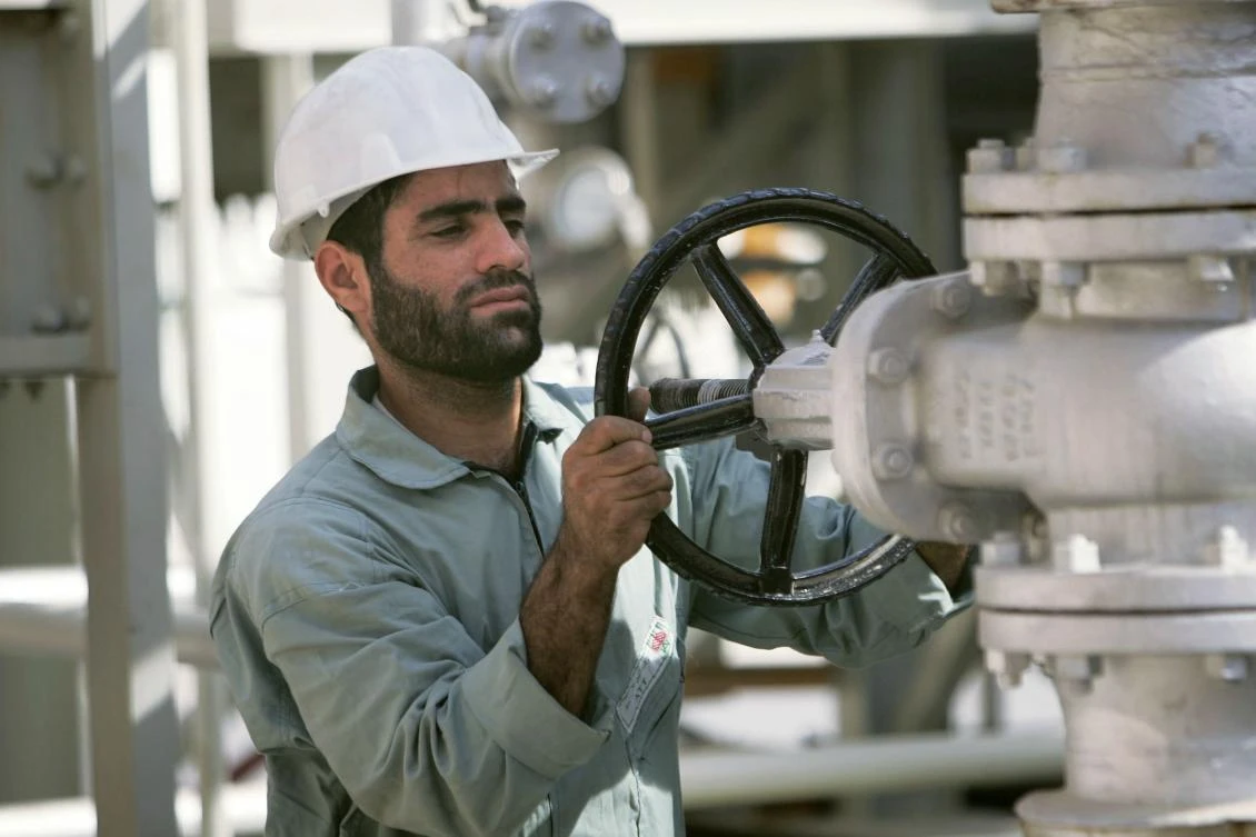 The US plans to re-introduce sanctions against Iran, which produces around 4 percent of global oil supplies. Above, an Iranian oil worker on the Arabian Gulf. (Reuters)