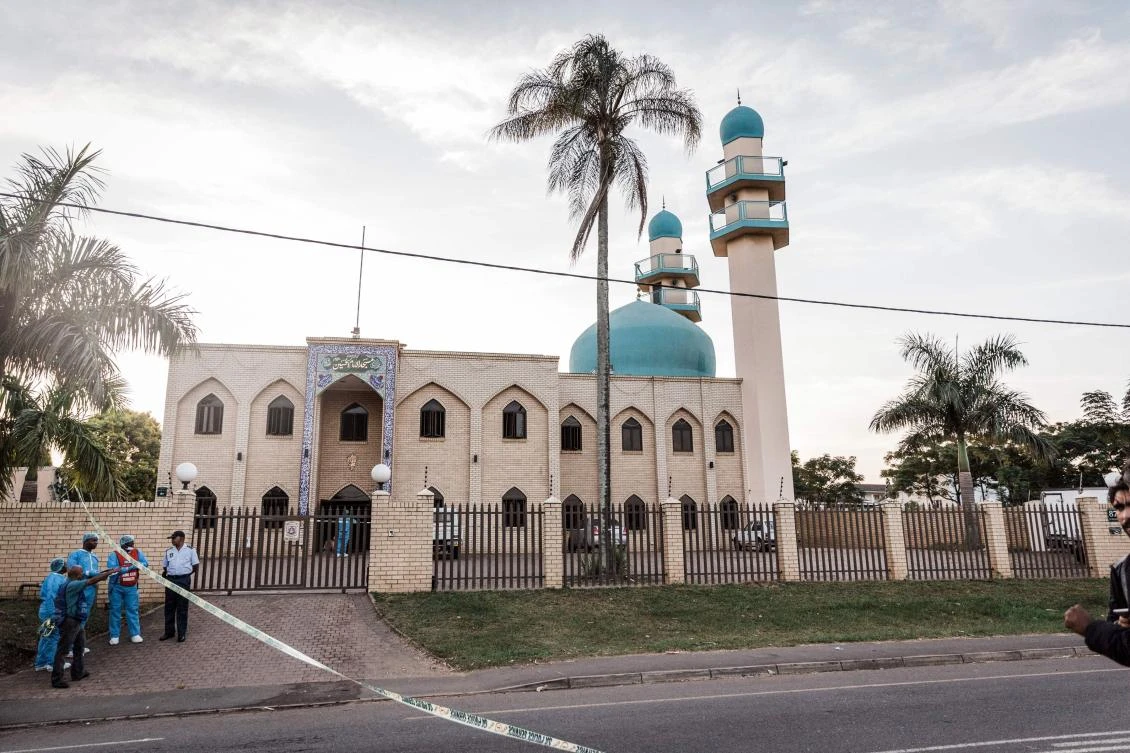 Police investigators gather at the entrance to the Imam Hussain Mosque on the outskirts of Durban on May 10, 2018, after an attack which left one person dead and two injured. (AFP)