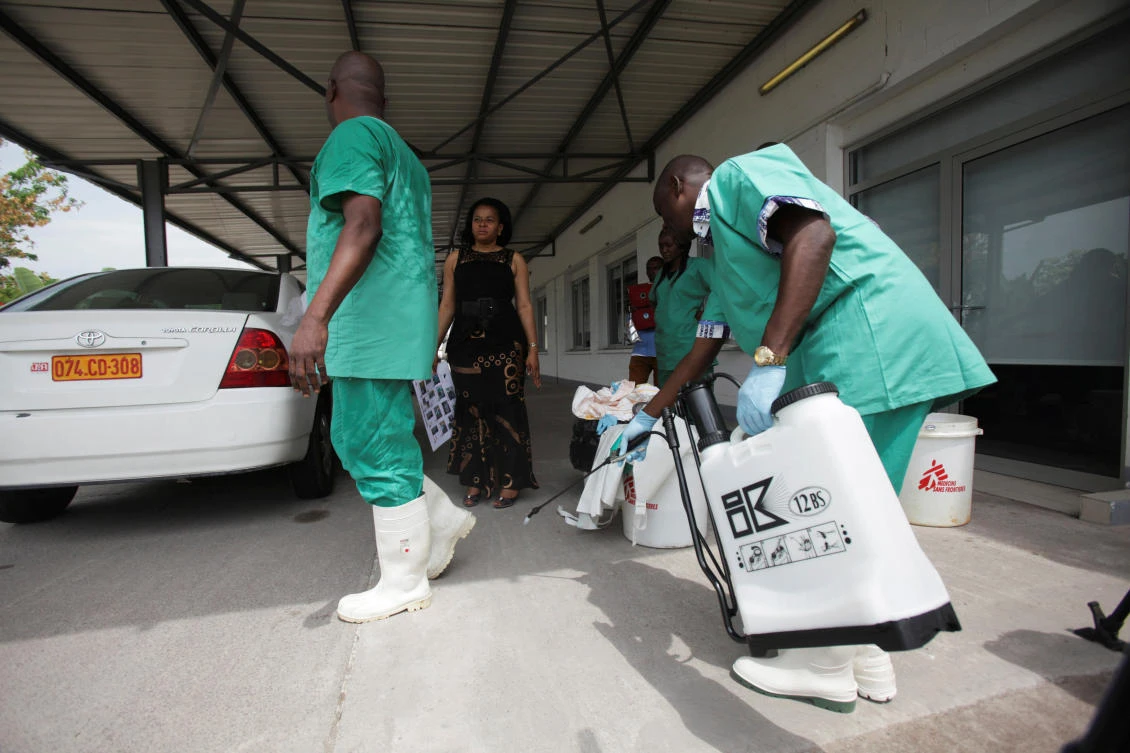 In this file photo, a health worker sprays a colleague with disinfectant during a training session for Congolese health workers to deal with Ebola virus in Kinshasa. (Reuters)