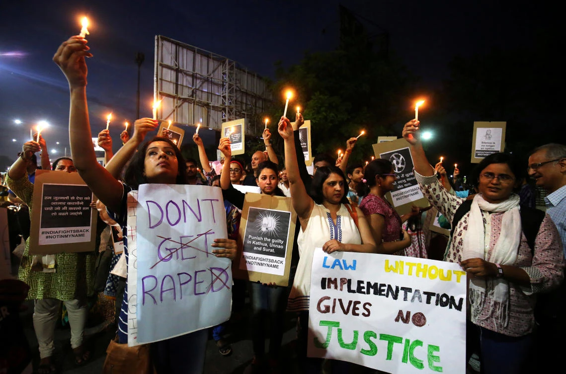 In this file photo, people hold candles and placards during a protest against the rape of an eight-year-old girl, in Kathua, near Jammu, a teenager in Unnao, Uttar Pradesh, and an eleven-year-old girl in Surat, Gujarat, in Ahmedabad, India. (Reuters)