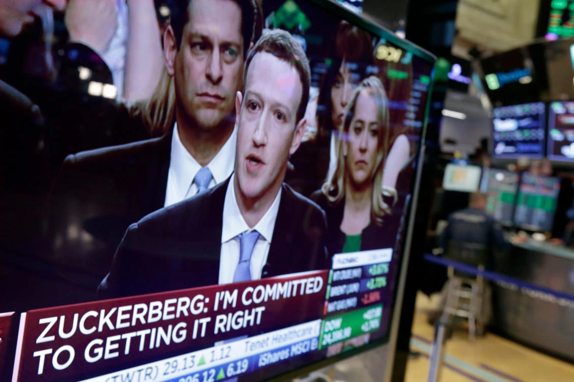 File photo showing Mark Zuckerberg on a television screen of the New York Stock Exchange as he testifies in the Senate in Washington (AP)