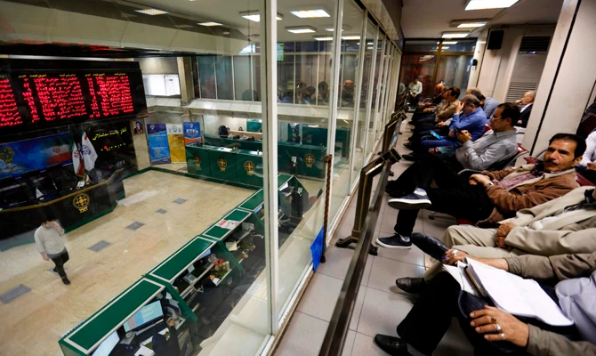 Iranians monitor the stock market at the stock exchange in Tehran on May 8, 2018. Renewed nuclear sanctions would certainly cause severe problems for Iran's economy, but much of the damage has already been done by the uncertainty created by the US and myriad home-grown problems. (AFP / ATTA KENARE)
