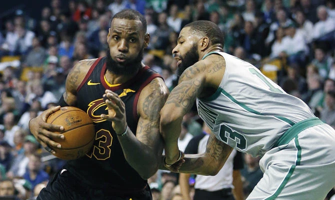 In this Feb. 11, 2018, file photo, Cleveland Cavaliers' LeBron James (23) drives against Boston Celtics' Marcus Morris (13) during the third quarter of an NBA basketball game in Boston. (AP Photo/Michael Dwyer, File)