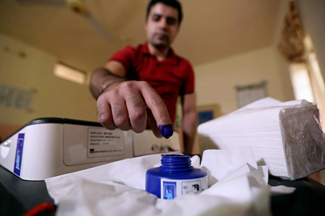 An Iraq man inks his finger after casting his ballot in the country’s parliamentary elections in Ramadi, Iraq, Saturday, May 12, 2018. (AP)