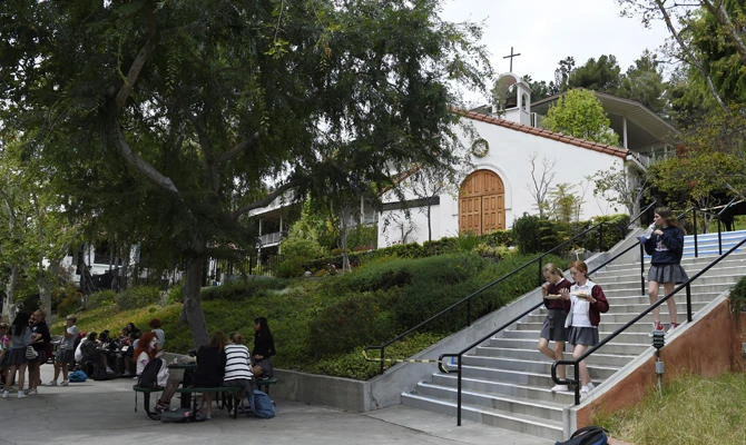 This April 30, 2018 photo shows students walking around campus at Immaculate Heart High School in Los Angeles. Meghan Markle, who is set to marry Prince Harry on May 19, graduated from the school in 1999. (AP Photo/Chris Pizzello)