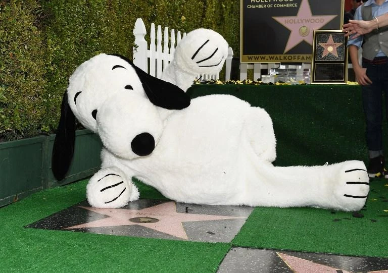 Snoopy poses on his star at the star unveiling ceremony on the Hollywood Walk of Fame on November 2, 2015 in Hollywood. Sony’s music unit is buying a stake in Peanuts Holdings, the company behind Snoopy and Charlie Brown. (AFP)