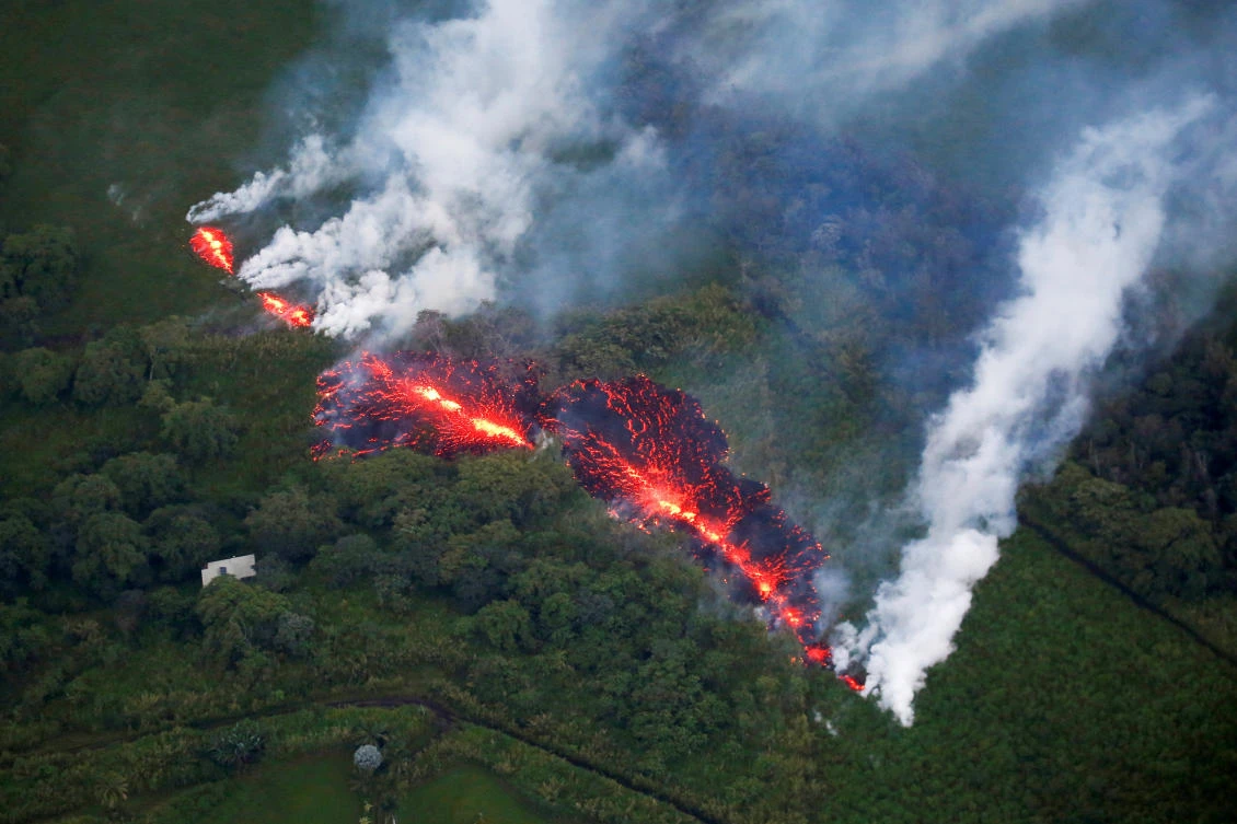 Lava erupts from a fissure east of the Leilani Estates subdivision during ongoing eruptions of Kilauea volcano in Hawaii. The US Geological Survey warned that fissures could erupt throughout the area and issued a new order to evacuate. (Reuters)
