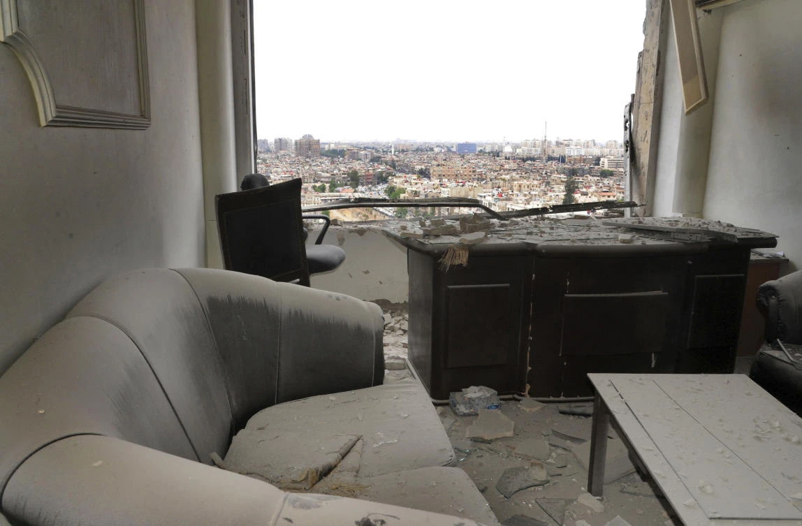 Above, a damaged office hit by shelling Daesh fighters on Wednesday, May 9. The Iraqi air force has already carried out several air strikes against Daesh in Syria since last year. (SANA via AP)