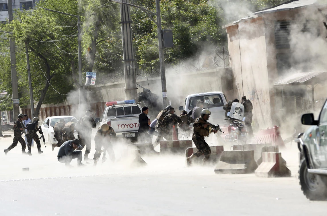 Security forces run from the site of a suicide attack in Kabul on Monday, April 30. The insurgent group earlier announced the start of its annual spring offensive on Wednesday, dismissing an offer for peace talks by President Ashraf Ghani. (AP)