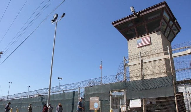 In this file photo, people walk past a guard tower outside the fencing of Camp 5 at the US Military's Prison in Guantanamo Bay, Cuba on Jan. 26, 2017. (AFP)