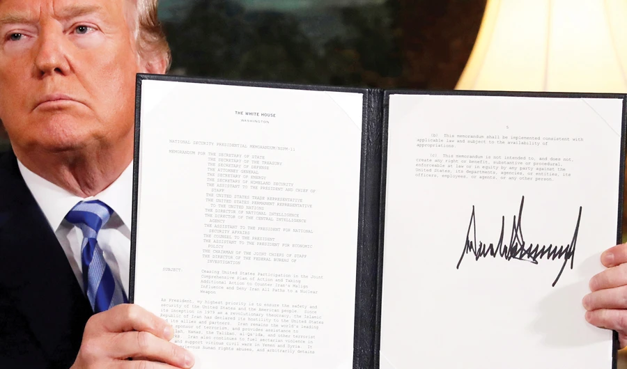US President Donald Trump holds up a proclamation declaring his intention to withdraw from the Iran nuclear agreement. (REUTERS/File)