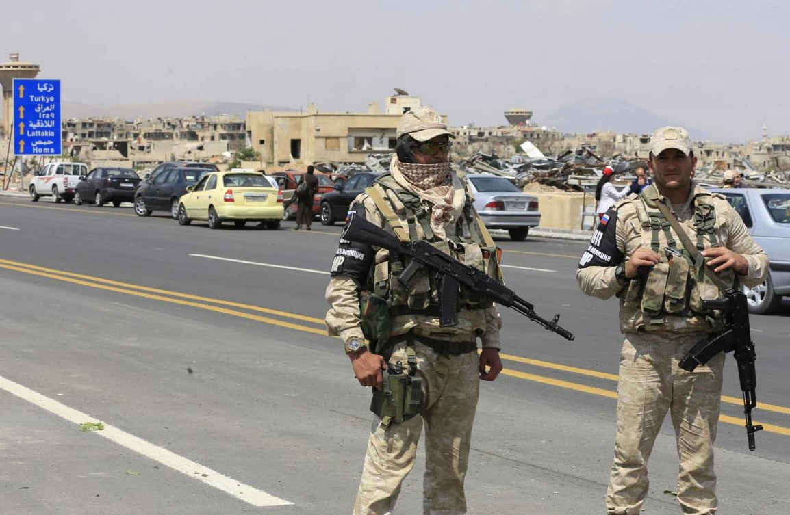 Members of the Russian Military Police stand on the highway extending from Harasta in Eastern Ghouta on the outskirts of Damascus. The Syrian government has reconquered swathes of territory it lost with Iranian and Russian support. (AFP)