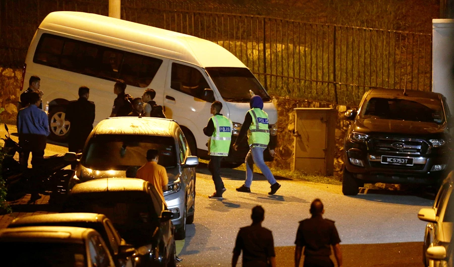 Police arrive at former prime minister Najib Razak's residence in Kuala Lumpur. (Reuters)